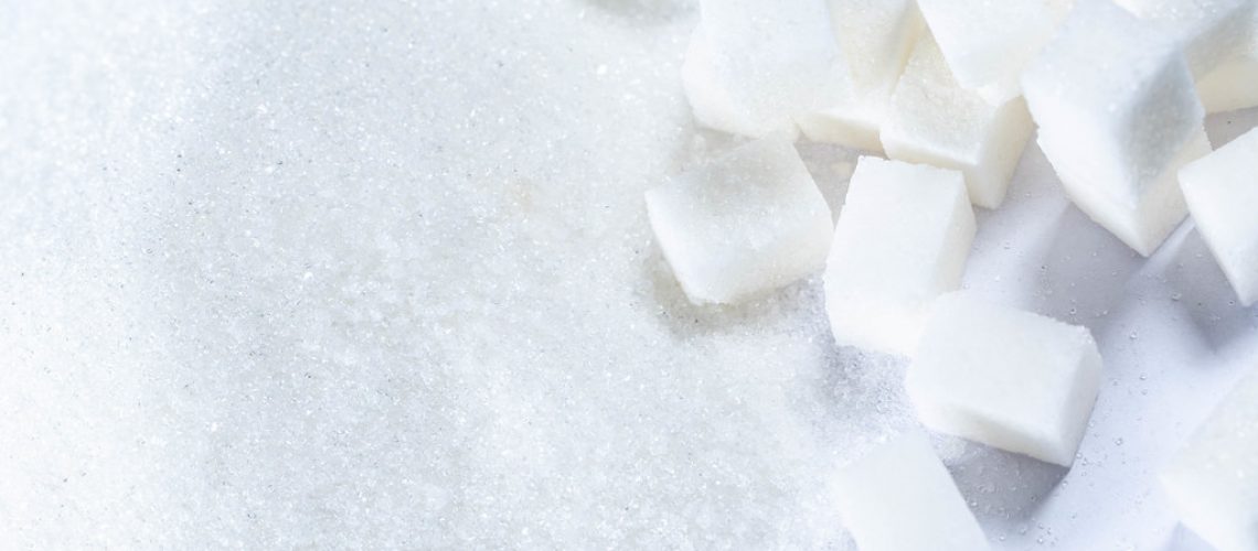 Refined sugar and granulated sugar on white background
